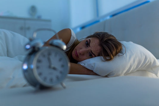眠れない女性と時計の写真